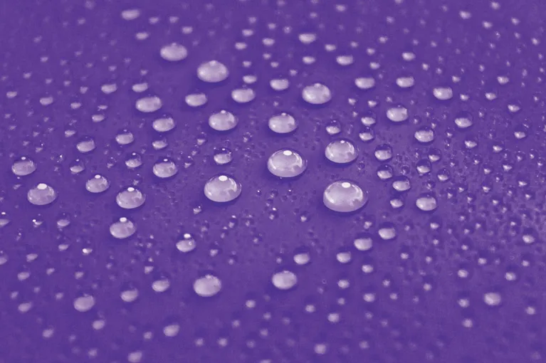 Water beading on a ceramic-coated purple surface
