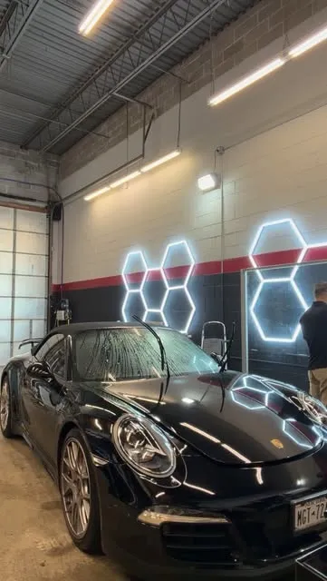 Car in the Nash install bay under hex lighting
