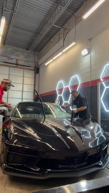 Nash installers fitting film in the hex-lit install bay in Ronkonkoma