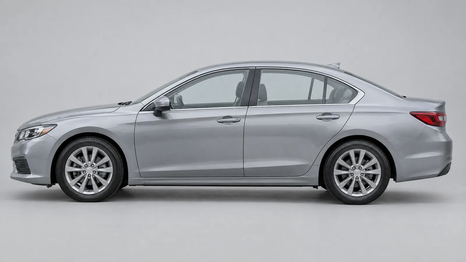Side view of a silver sedan with clear, untinted windows