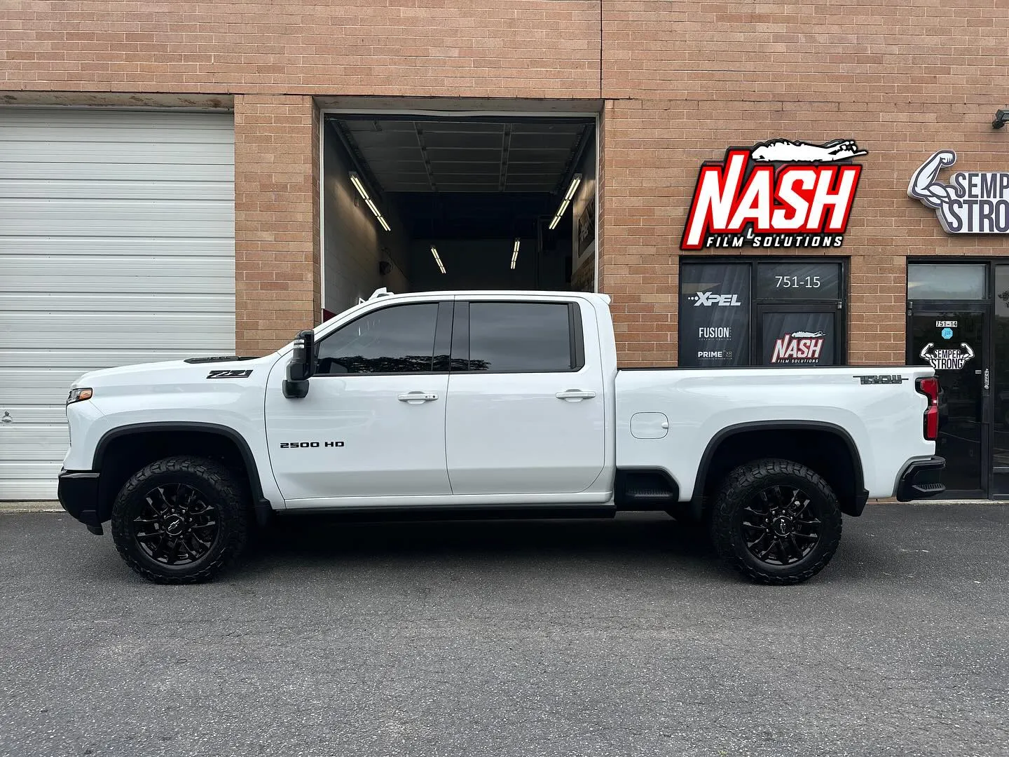 White Chevrolet Silverado outside the Nash Film Solutions shop